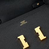 Hermès black Epsom leather Constance Long To Go clutch with gold H turn lock and HERMÈS PARIS stamp.