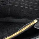 Black Epsom leather clutch interior with gold zipped purse, tonal Swift lining, and slit compartments.