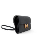 Black Epsom leather Constance Long To Go clutch with gold H clasp, gusseted compartments, and detachable strap.